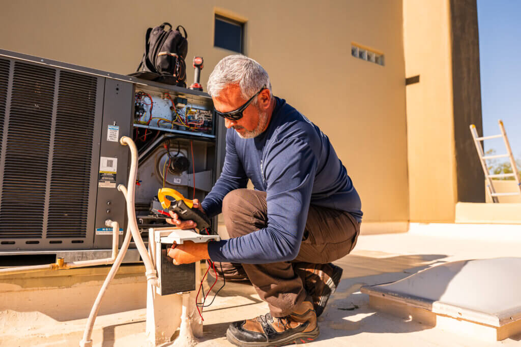 Heating repair Tucson specialist using diagnostic tools to inspect a residential heating system for optimal performance.