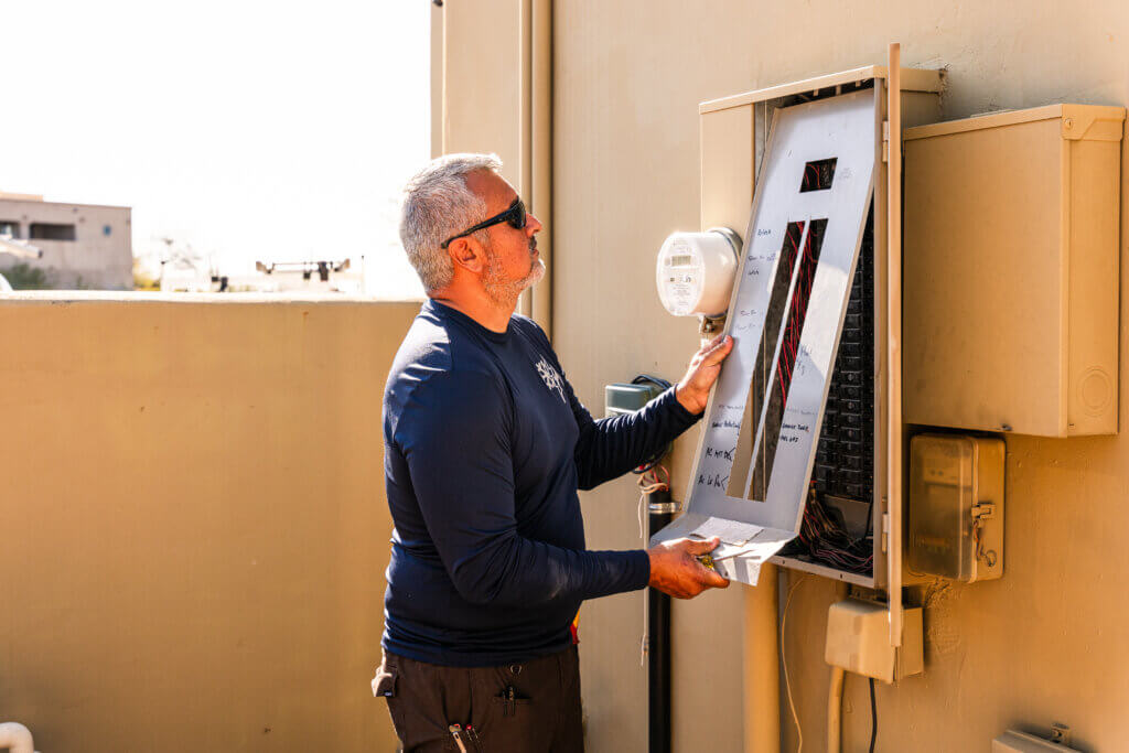 Technician from one of the trusted HVAC companies Tucson homeowners rely on inspecting and replacing an HVAC air filter during routine maintenance.